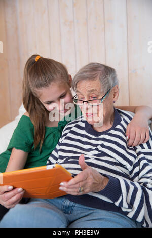 Grandmother and granddaughter using tablet Stock Photo