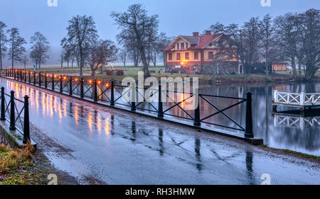 Old stone bridge decorated with lit light bullbs early in the morning by Nääs art gallery outside Gothenburg in Sweden Stock Photo