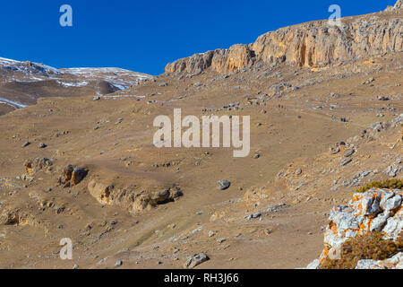 A group of tourists walking along the path in the mountains Stock Photo