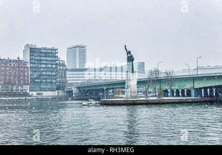 Snownfall over Replica of the Statue of Liberty in Paris Stock Photo
