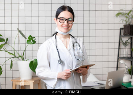 Portrait of female doctor using her digital tablet in the office Stock Photo