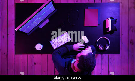 Bearded programmer hacker waiting for program to process. Tired programmer looking at monitor happy about the result. Stock Photo