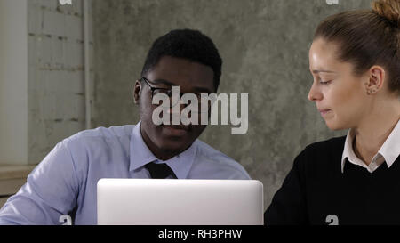 Two managers working on laptop Stock Photo
