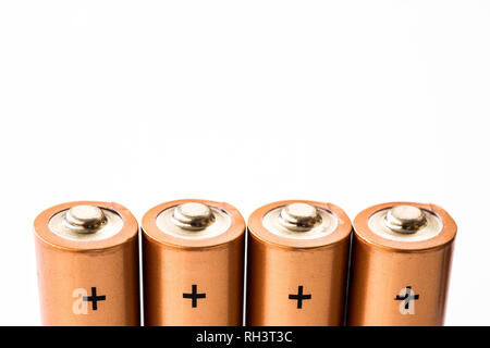 A close up of the positive terminals of disposable AAA batteries on a white background with copy space Stock Photo