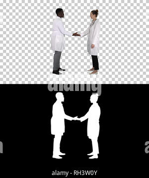 Successful team of surgeons giving high five and laughing isolated on white background, Alpha Channel Stock Photo