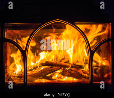 Roaring flames from a fire burning in a wood-burning stove in winter Stock Photo
