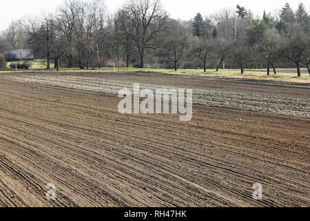 Furrows on a freshly ploughed field in March Stock Photo