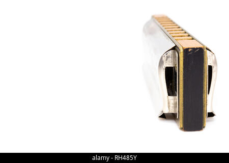 Musical instrument - blues harp side view isolated on white Stock Photo