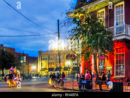 People wait outside Circle Bar for the Krewe of Hermes Mardi Gras parade at Lee Circle, Feb. 28, 2014, in New Orleans, Louisiana. Stock Photo