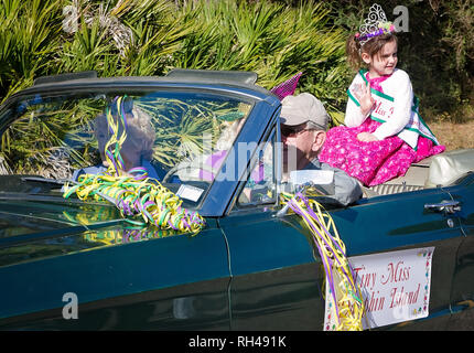 Tiny Miss Dauphin Island waves to the crowd as she rides in Dauphin Island’s first People’s Parade during Mardi Gras, Feb. 4, 2017, Stock Photo