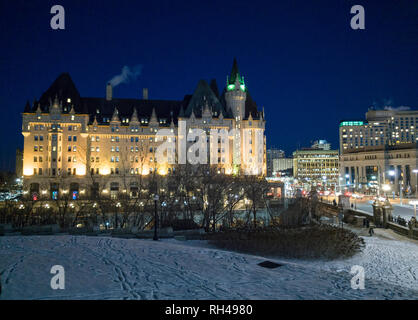 Chateau Laurier at Night from Parliament Hill: The iconic hotel floodlit on a cold winter night with Wellington's street lights and snowy ground below. Stock Photo