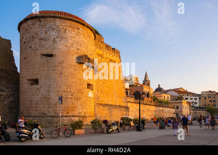Alghero, Sardinia / Italy - 2018/08/10: Summer sunset view of the Alghero old town quarter with historic defense walls and fortifications Stock Photo