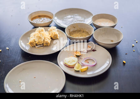 Plates with crumbs of food. Remains of food in plates after lunch or dinner Stock Photo