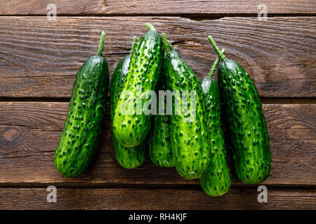 Fresh green cucumbers on wooden background. Top view Stock Photo