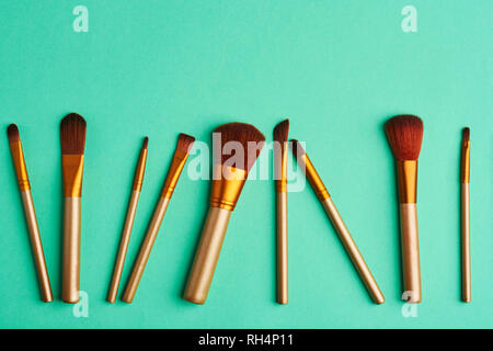 Makeup brushes, everyday make-up tools. Cosmetic essentials on bright background, flat lay Stock Photo
