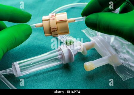 Doctor holds a flow dial on a hospital table, conceptual image Stock Photo