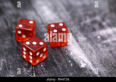 Red dice on vintage wooden table. Background for casino games, gambling, luck or randomness Stock Photo