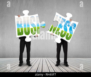 Holding puzzles for assembling on wooden floor Stock Photo