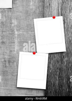 Two blank square instant photo frames against gray scratched wooden boards background Stock Photo