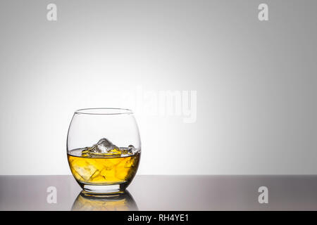 https://l450v.alamy.com/450v/rh4ye1/a-back-lit-oval-glass-of-golden-whiskey-with-ice-on-a-high-gloss-base-against-a-white-background-rh4ye1.jpg