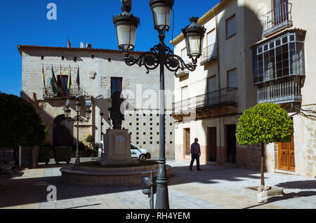 Castellar, Jaen province, Andalusia, Spain : A man walks past the town hall placed at the Palacio de la Casa Ducal de Medinaceli in Plaza de la Consti Stock Photo