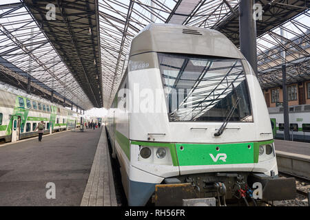 HELSINKI, FINLAND - SEPTEMBER 21, 2014: train at Helsinki Central railway station. It is a widely recognised landmark in Kluuvi, part of central Helsi Stock Photo