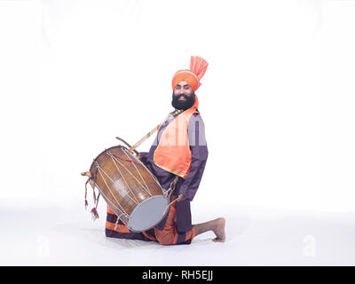 PORTRAIT OF A  BHANGRA DANCER PLAYING THE DRUM, DHOL Stock Photo