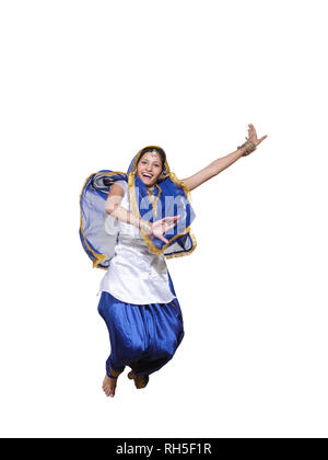 PORTRAIT OF A SARDARNI, SIKH WOMAN JUMPING DANCING THE BHANGRA Stock Photo