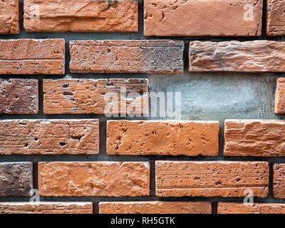 Close-up brick wall background with missing brick. Empty space from missing brick from the wall. Stock Photo