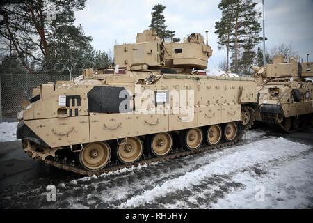 U.S. Army vehicles assigned to the 91st Brigade Engineer Battalion, 1st Armored Brigade Combat Team, 1st Cavalry Division stage after receiving the proper stamping during rail head operations in Grafenwoehr, Germany Jan. 30, 2019. The 91st Engineers along with other members of the 1-1CD IRONHORSE Brigade are setting their sites on home and the next mission as they close out their support of Atlantic Resolve.  (U.S. Army National Guard photo by Sgt. 1st Class Ron Lee, 382nd Public Affairs Detachment, 1ABCT, 1CD released) Stock Photo