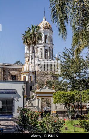 The lateral part with its metal gate of the church of San Pedro Apóstol in a wonderful and sunny day in Tlaquepaque Jalisco Mexico Stock Photo