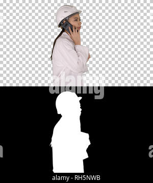 Female science engineer making a call while walking, Alpha Channel Stock Photo