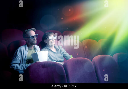 Teenager couple cuddling and watching the climax part of the movie Stock Photo