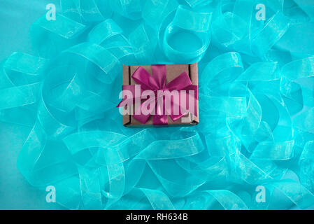Abstract textured blue background. Ribbon curls top view Stock Photo