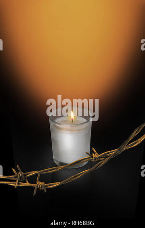 International Holocaust Memorial Day, Yarhtzeit Candle and barbed wire, Remembering Loved One Stock Photo