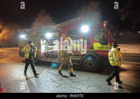 Tullibody, Clackmannanshire, UK. 31st Jan, 2019. Two Police officers are seen walking on to the scene with a member of the Fire Service is seen in full respiratory system.A car caught fire tonight on the B9096 in Tullibody. Fire & Rescue and Police were on scene. There were no injuries.Fire & Rescue brought the fire under control and put it out. Credit: Stewart Kirby/SOPA Images/ZUMA Wire/Alamy Live News Stock Photo