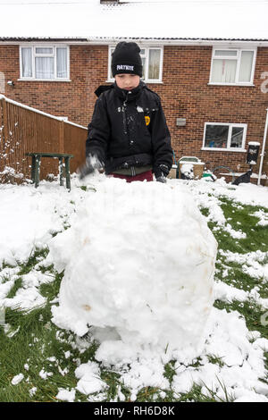 Reading, UK. 1st Feb 2019. UK Weather: Young boys play in the snow in a back garden in Reading and make a snowman. Three inches of snow fell overnight and school is cancelled for the day. Matthew Ashmore/Alamy Live News Stock Photo