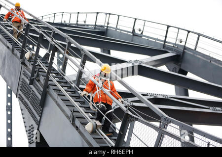 (190201) -- JIUJIANG, Feb. 1, 2019 (Xinhua) -- Bridge workers walk on the Jiujiang Yangtze River Bridge, a double-decked road-rail truss bridge and an important section of Beijing-Kowloon (Jingjiu) Railway in Jiujiang, east China's Jiangxi Province, Jan. 31, 2019. Safety inspections have been strengthened to secure transportation during the 2019 Spring Festival travel rush. (Xinhua/Ding Bo) Stock Photo