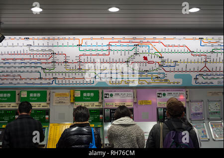 30.12.2017, Tokyo, Japan, Asia - Commuters are queueing up in front of ticket vending machines at a subway station in the city centre. Stock Photo