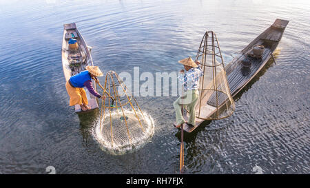 Lake Inle/ Myanmar- January 12,2019: traditional Intha fisherman in long boat in the early morning on Lake Inle