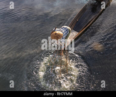 Lake Inle/ Myanmar- January 12,2019: traditional Intha fisherman in long boat in the early morning on Lake Inle
