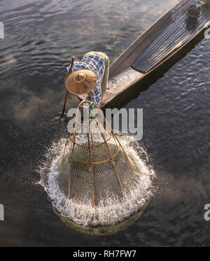 Lake Inle/ Myanmar- January 12,2019: traditional Intha fisherman in long boat in the early morning on Lake Inle