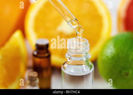citrus essential oil dripping from dropper Stock Photo