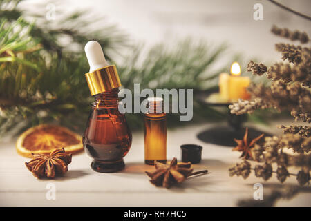aromatherapy treatment - essential oil bottles with herbs Stock Photo