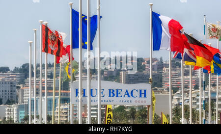NICE, FRANCE - MAY 29, 2018: Flags flying at Blue Beach on the Promenade des Anglais Stock Photo