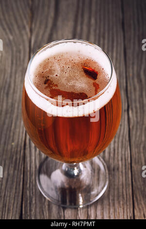 Full glass of filtered light beer on a wooden table, closeup Stock Photo