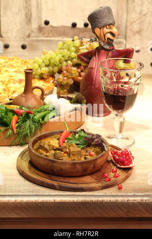 Fried chicken hearts, stomachs with garlic and pomegranate seeds with wine Stock Photo