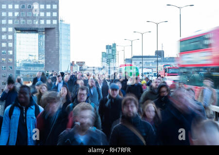 Crowd Of Commuters Walking To Work Across London Bridge UK With Motion Blur Effect Stock Photo
