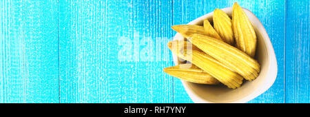 Baby sweetcorn or mini corn. It is typically the eaten whole cob included for the human consumption. It is eaten both raw and cooked. Baby corn is com Stock Photo