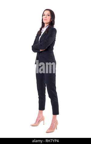 Side view of confident successful female business manager with crossed arms looking at camera. Full body isolated on white background. Stock Photo